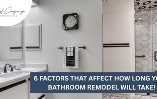 Modern bathroom with double sinks, white cabinets, hexagonal tile shower, and black and white decor. Text overlay: “6 Factors That Affect How Long Your Bathroom Remodel Will Take!”.