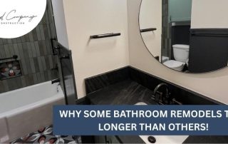 A modern bathroom features a bathtub, round mirror, toilet, and dark sink countertop with the text Why some bathroom remodels take longer than others!.